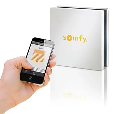 Somfy Smart Home Motorisation for Roller Blinds — Estores Málaga Somfy smart hub and smartphone app controlling motorised roller blinds in Málaga